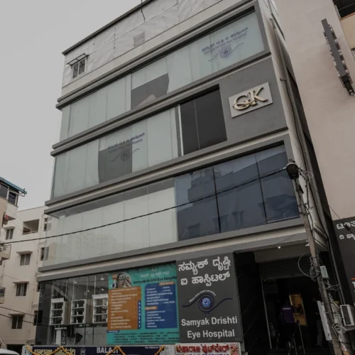 samyak-drishti-eye-hospital-facade-banner-subramanyapura-south-bangalore Exterior façade of Samyak Drishti Eye Hospital in Subramanyapura, South Bangalore — your neighbourhood eye care centre providing cataract, LASIK, retina and paediatric services.